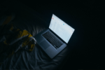 Laptop on bed at night