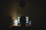 Man sitting at computer at night