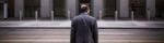 Man in suit walks into office building