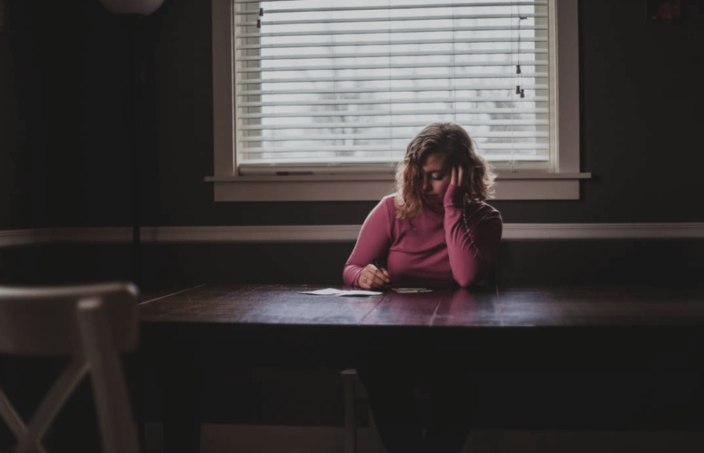 image of woman writing form for benefits blog