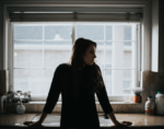 Woman standing in kitchen for energy price cap blog