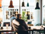 man sitting alone at table in coffee shop