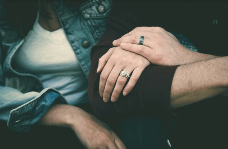 Photo of two people linking arms