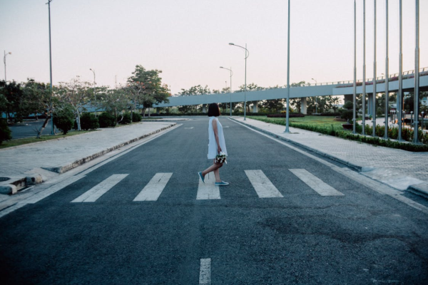 Dropped kerb universal design - fintech and mental health blog Photo of woman crossing road and dropped kerb illustrating universal design for fintech and mental health blog