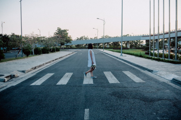 Photo of woman crossing road and dropped kerb illustrating universal design for fintech and mental health blog