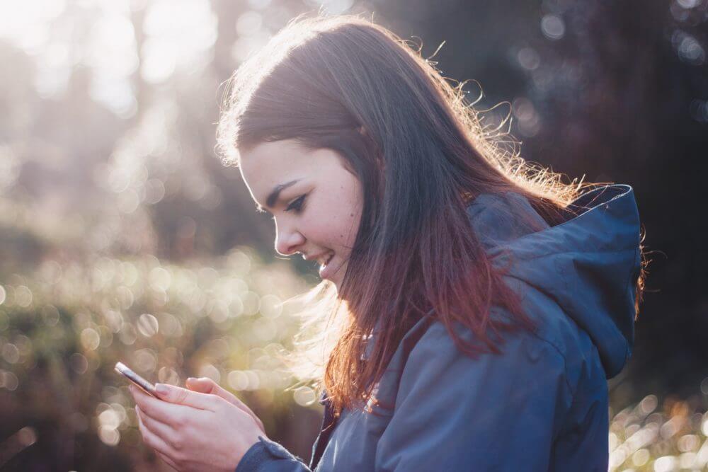 Woman using her fintech on her phone