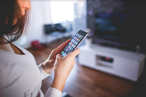 Woman using Touch ID functionality for fintech and mental health blog