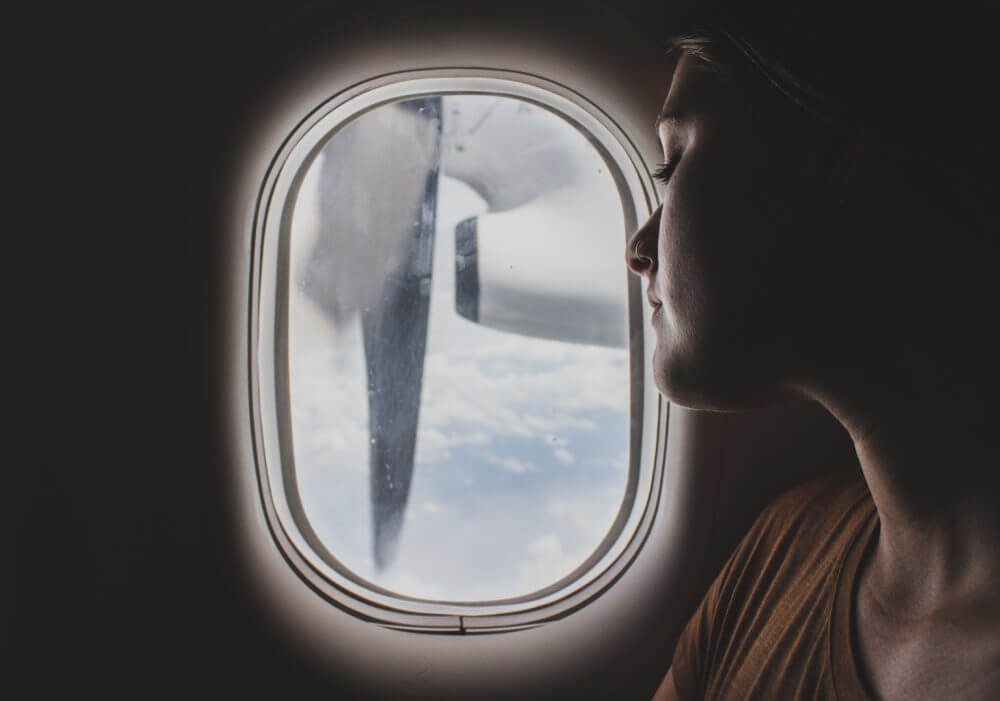 Woman sitting at the window of a plane