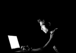 Photo of man at laptop for gambling and mental health blog