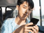 Man on bus with mobile phone.