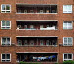 A photo of a block of flats with washing hanging up outside for blog about the rise in demand for charitable grants