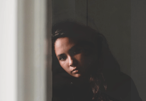 Woman leaning against wall