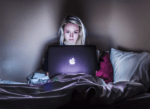Woman on laptop in dark for Monzo gambling block blog