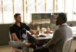 two men talking in an office