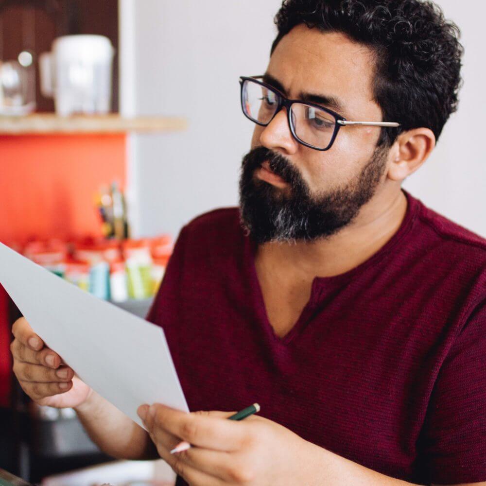 a man reading a piece of paper