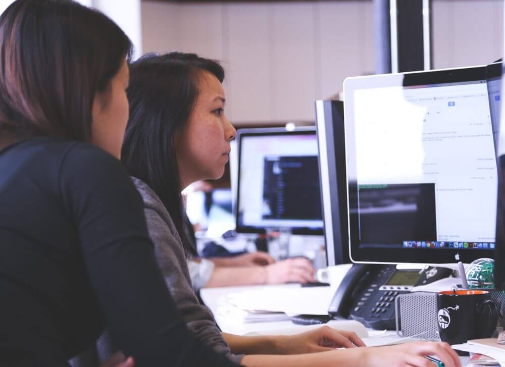 picture of two people with a computer