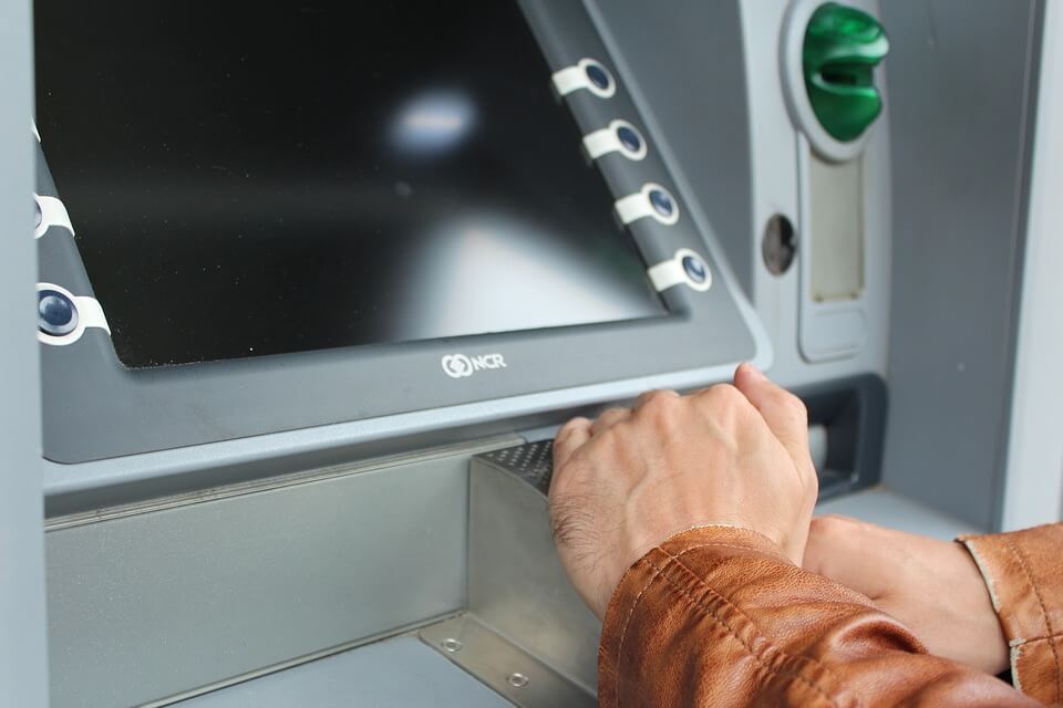 picture of a person using a cash machine