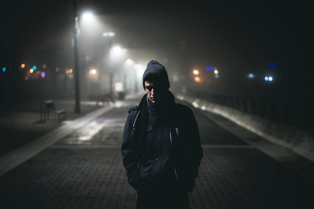 image of a lone man on a dark street
