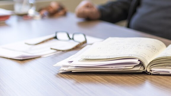 picture of a person sitting at a desk with paperwork