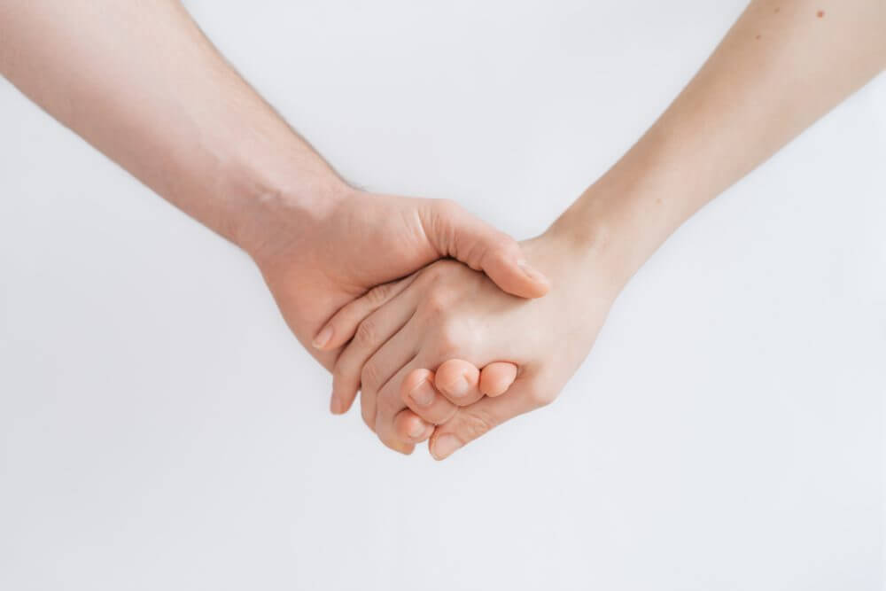 a picture of two people holding hands