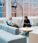 Two women sitting down talking