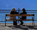 women chatting on bench