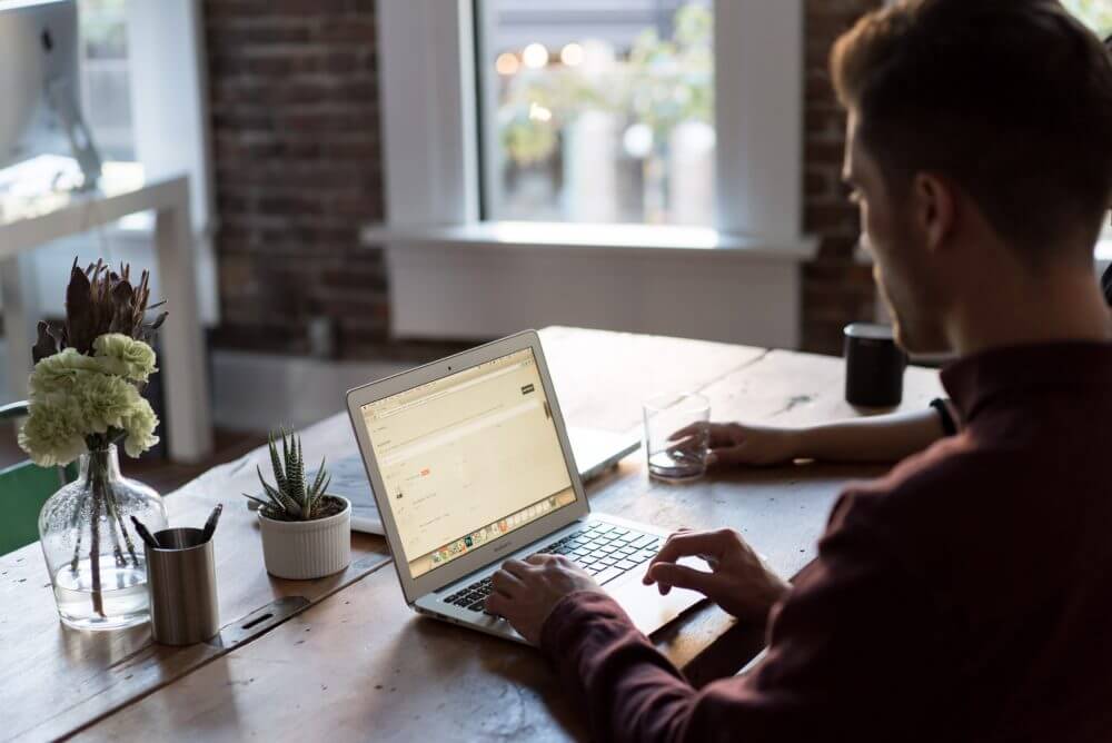 two men looking at laptop