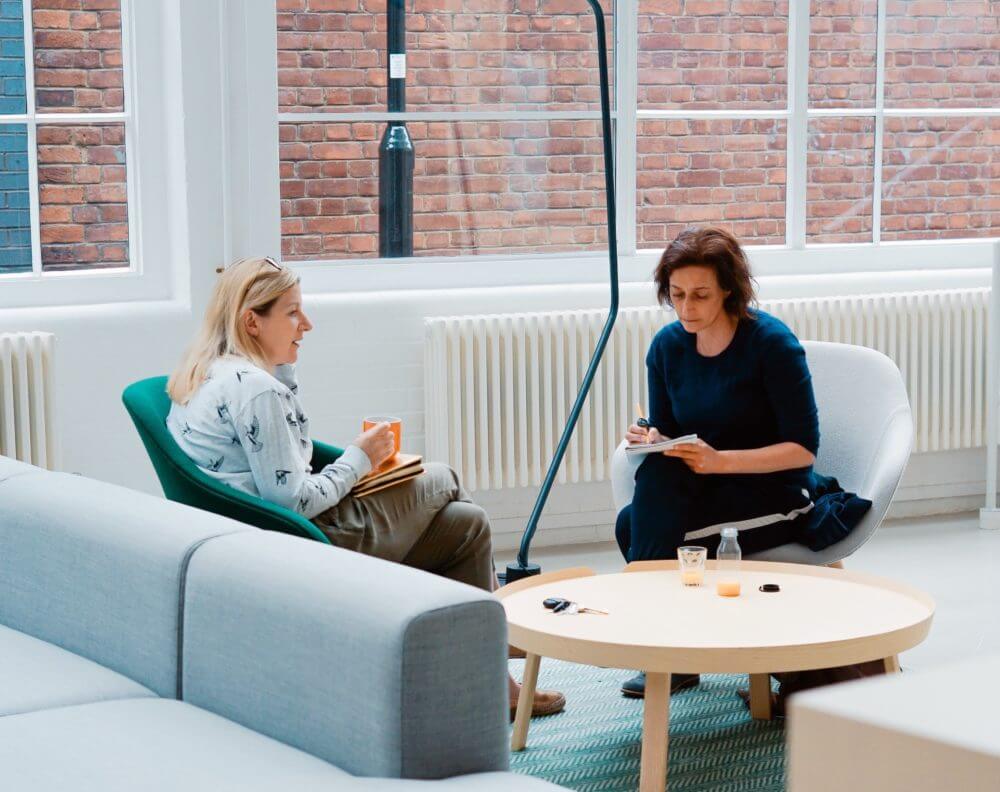 picture of two people in an office talking to eachother