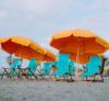 beach chairs on the sand with umbrella