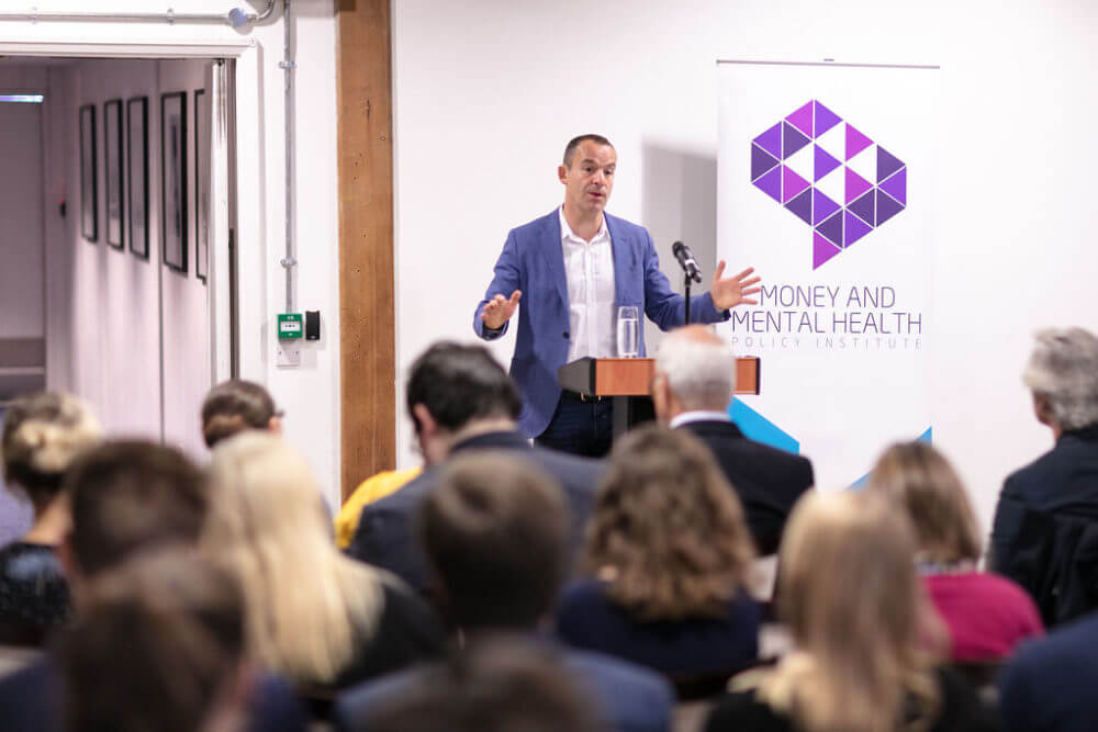 Martin Lewis in front of Money and Mental Health banner speaking to audience at Data Protecting launch event