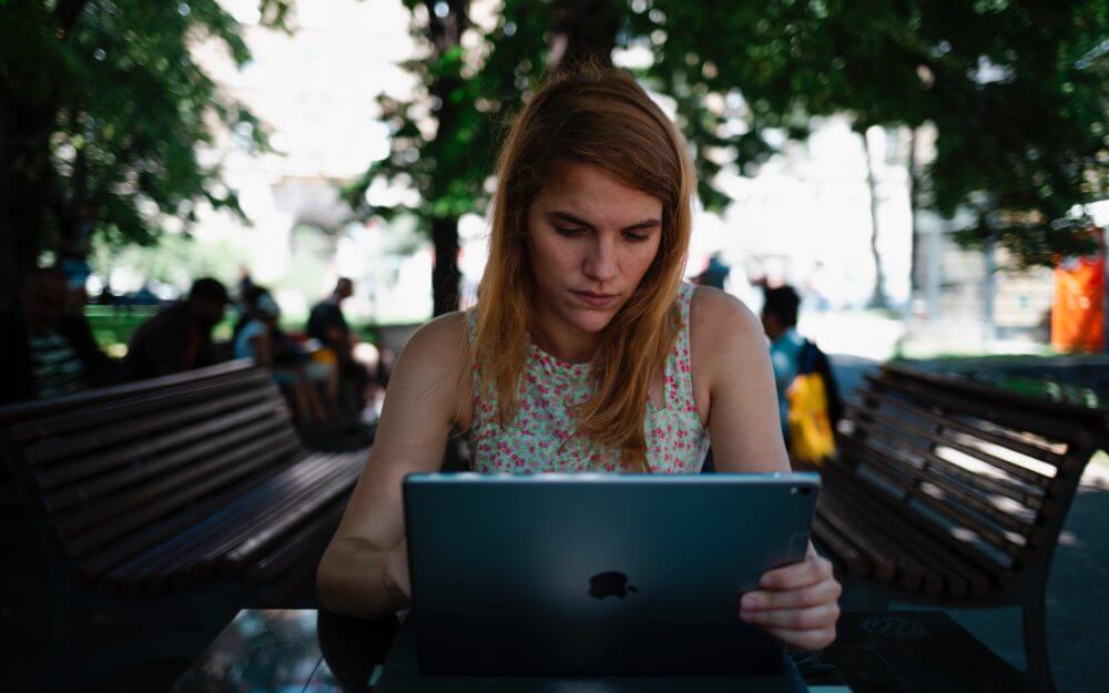 woman sitting down using an ipad