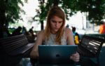 stefan-vladimirov-AR3DFArIaz0-unsplash woman sitting down using an ipad