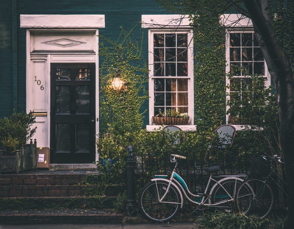 green house with a bicycle out the front