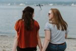 two girls chatting by the sea