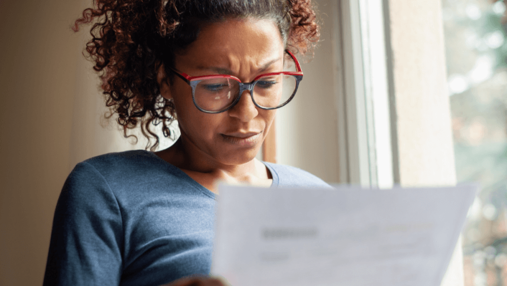 Woman frowning reading letter