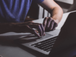 man using a laptop in a darkened room