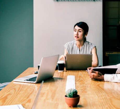 two people in a work meeting with laptops