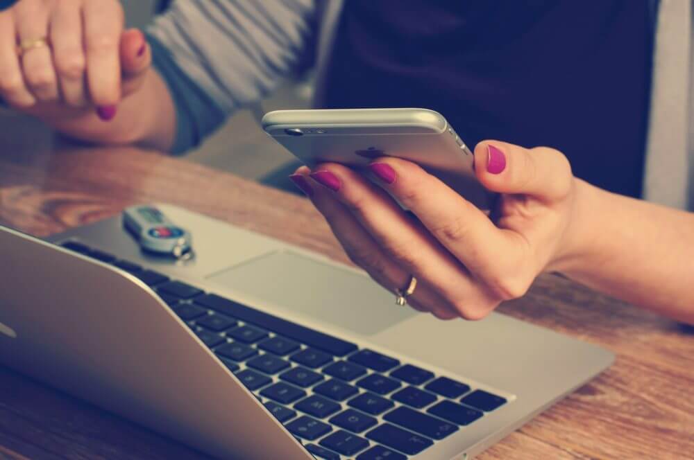 person working using laptop and phone