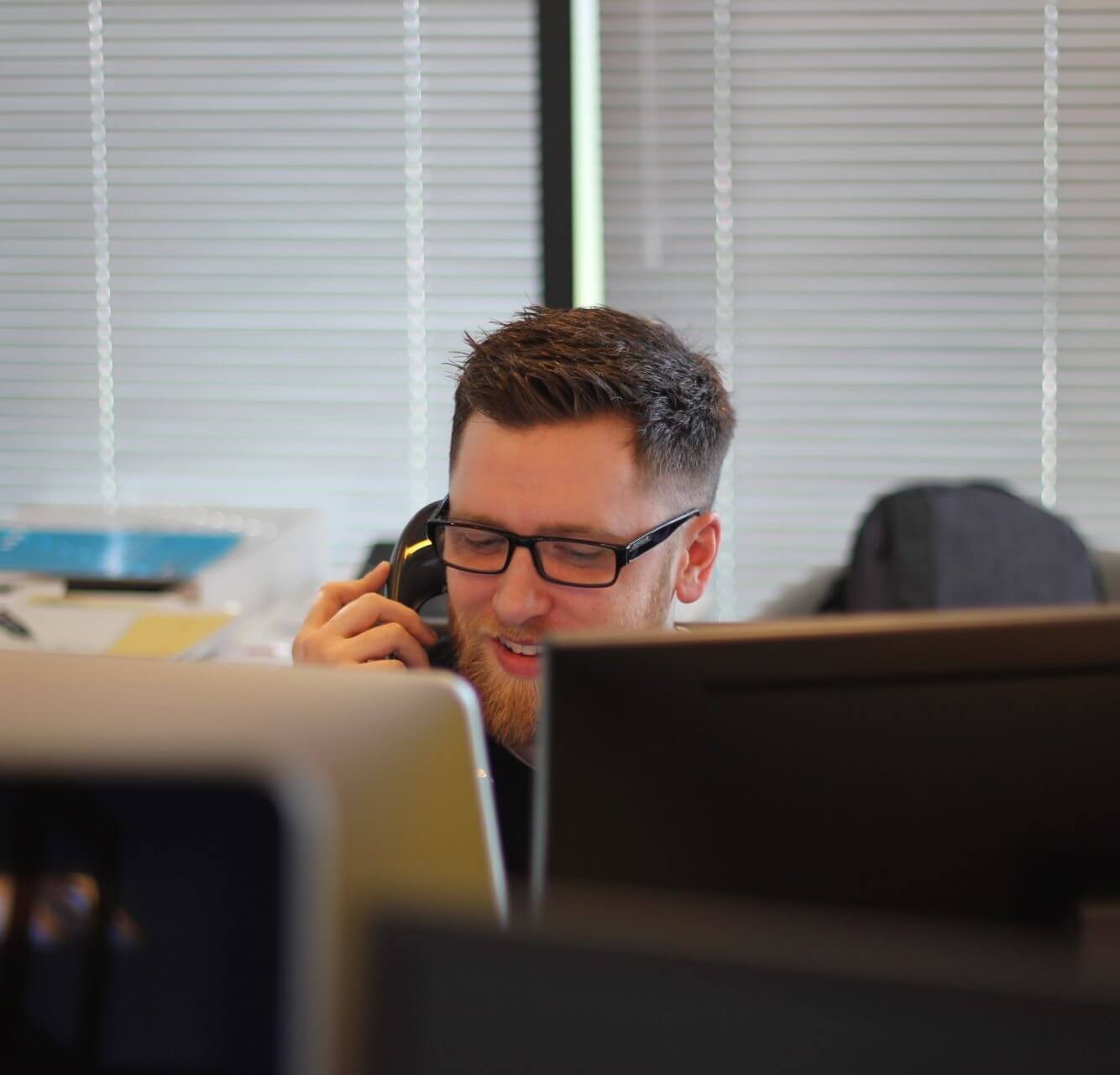 person at desk on the phone