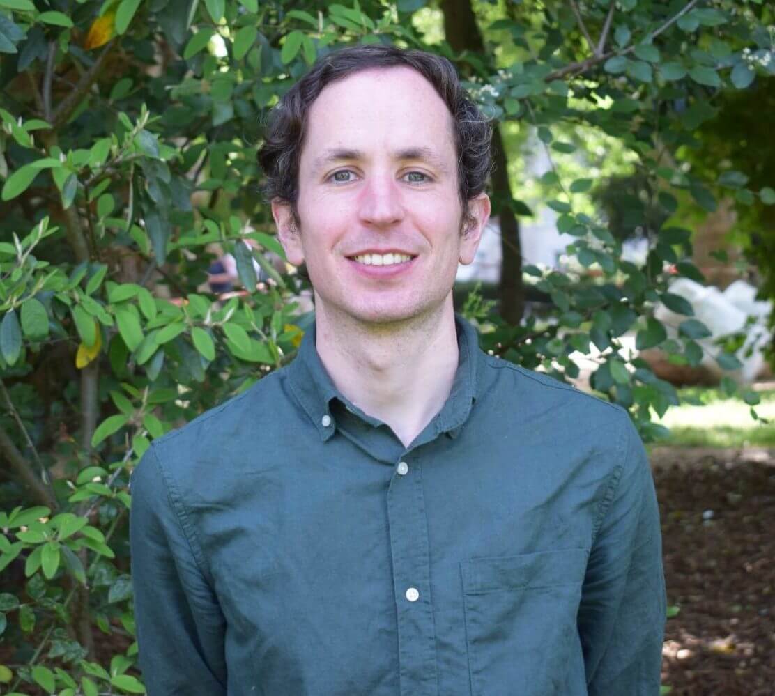 An image of Money and Mental Health's Conor D'Arcy - standing in front of some trees.