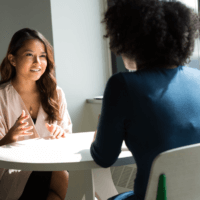 Two people in conversation in a workplace setting