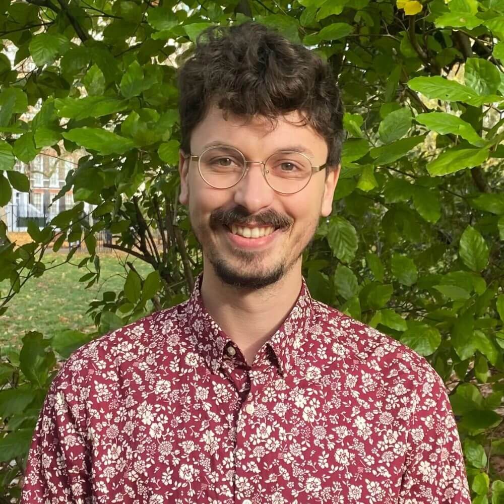 Photo of Liam Hill in front of greenery