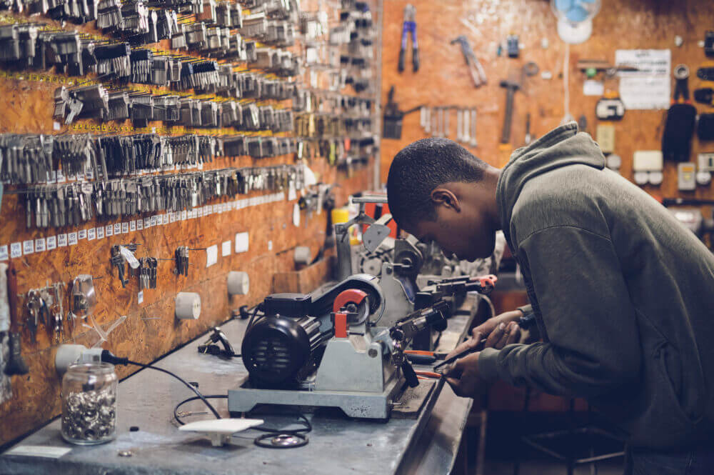 A man in a key-cutting workshop.