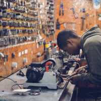 A man in a key-cutting workshop.