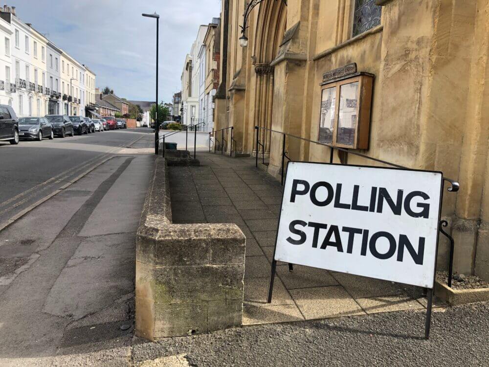 A photo of a sign that reads 'Polling station' on the pavement outside a polling station