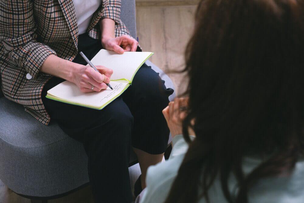 A person taking notes in a book