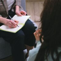 A person taking notes in a book