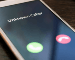 An image of a smartphone receiving a call from an Unknown Caller.