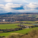 The countryside in the UK - featuring houses in the middle ground on the image.