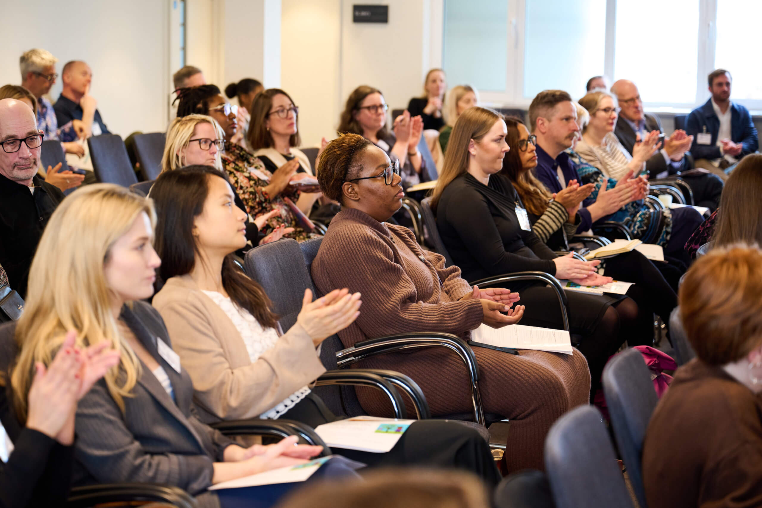 Attendees applauding at Money and Mental Health's launch event for Always on your mind.